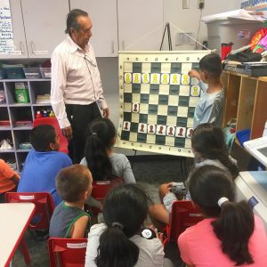 Volunteer teaching our children how to play Chess