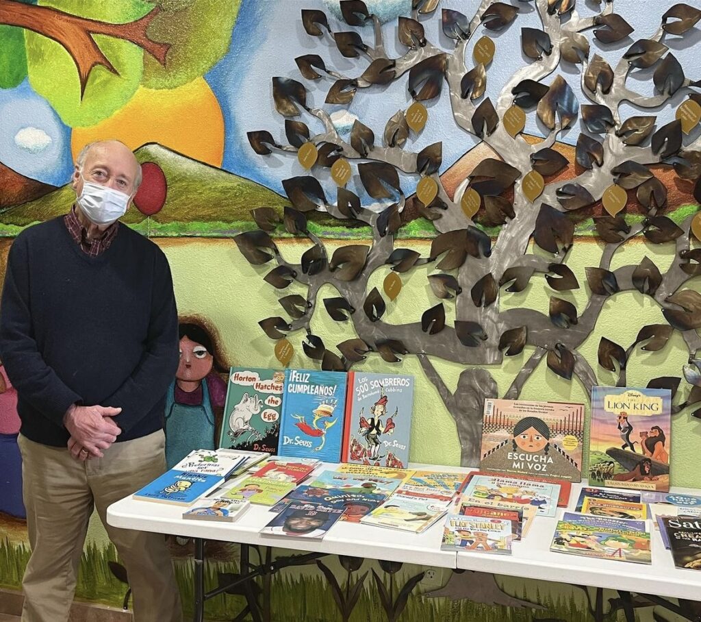 Volunteer with Children's Reading Alliance set up to give books to children and families.